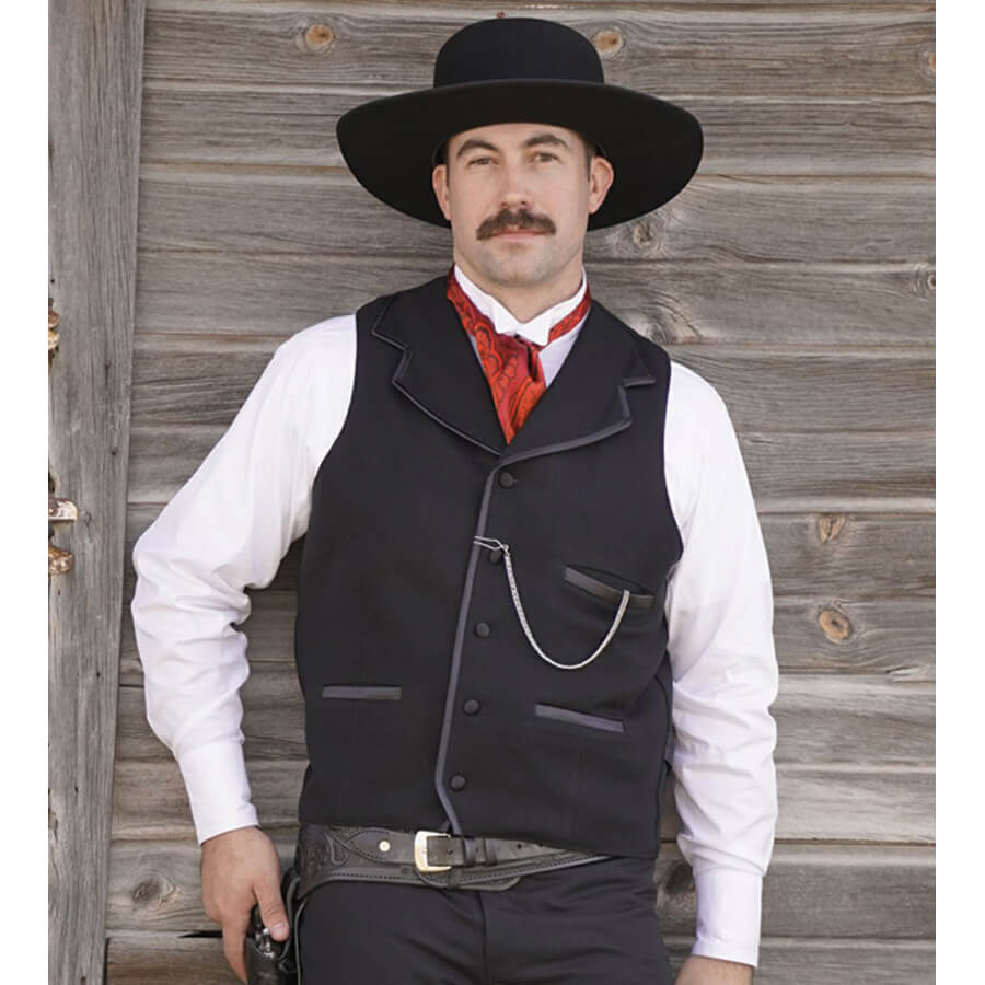 Similar to the vest worn by Kurt Russell as Wyatt Earp in “Tombstone”, this iconic style vest will help you walk the street in confidence. Notched lapels are sewn into the shoulder seam and trimmed in satin bias with three matching satin welt pockets and back belt. Made of 100% wool and lined in polyester. Dry Clean. Made in USA. 