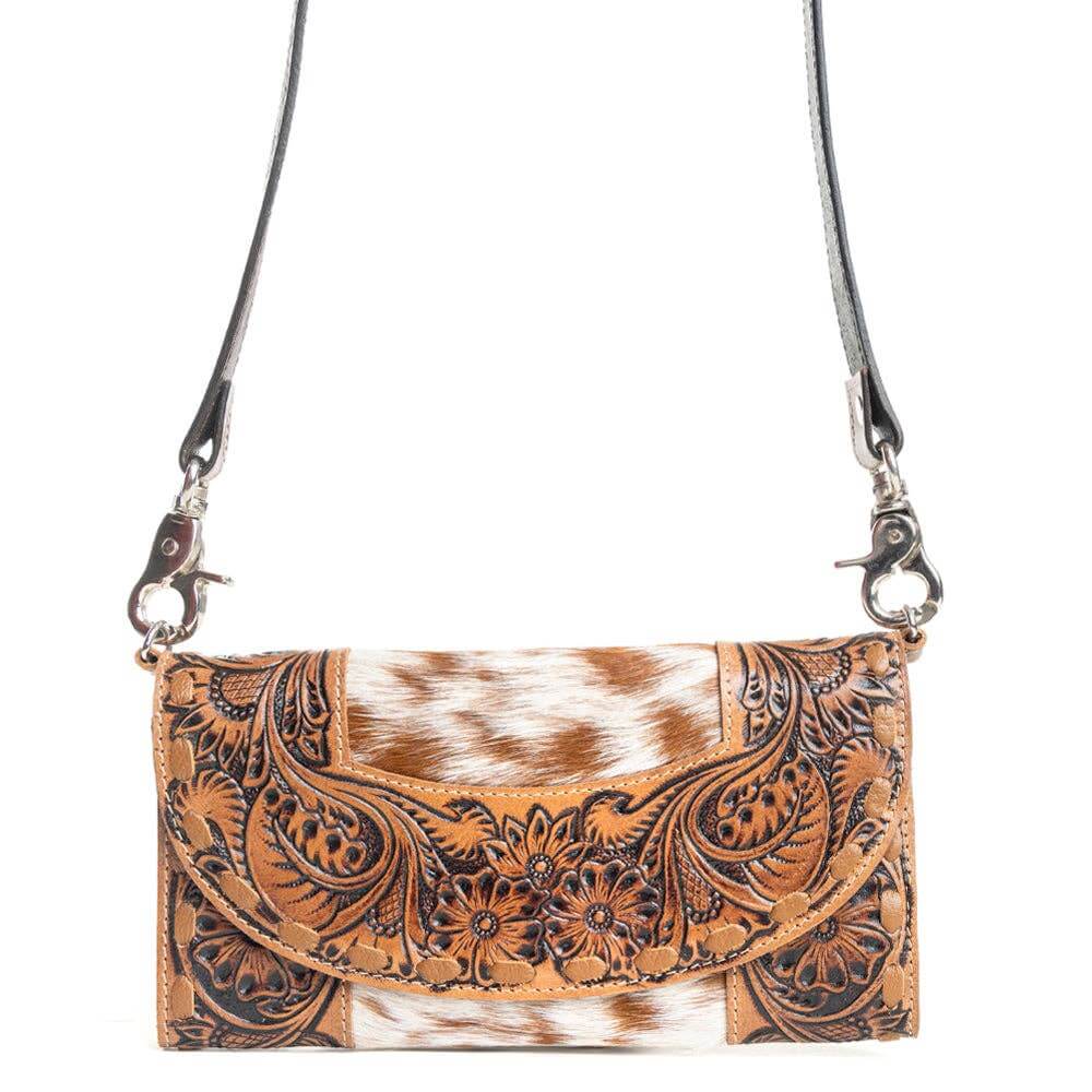 Brown leather crossbody bag with cowhide pattern on a white background