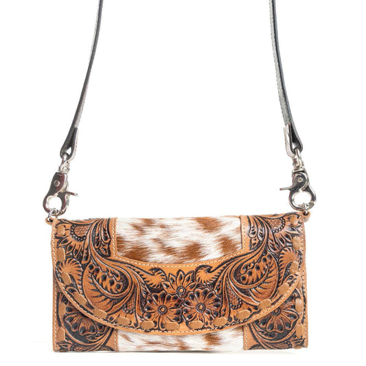 Brown leather crossbody bag with cowhide pattern on a white background