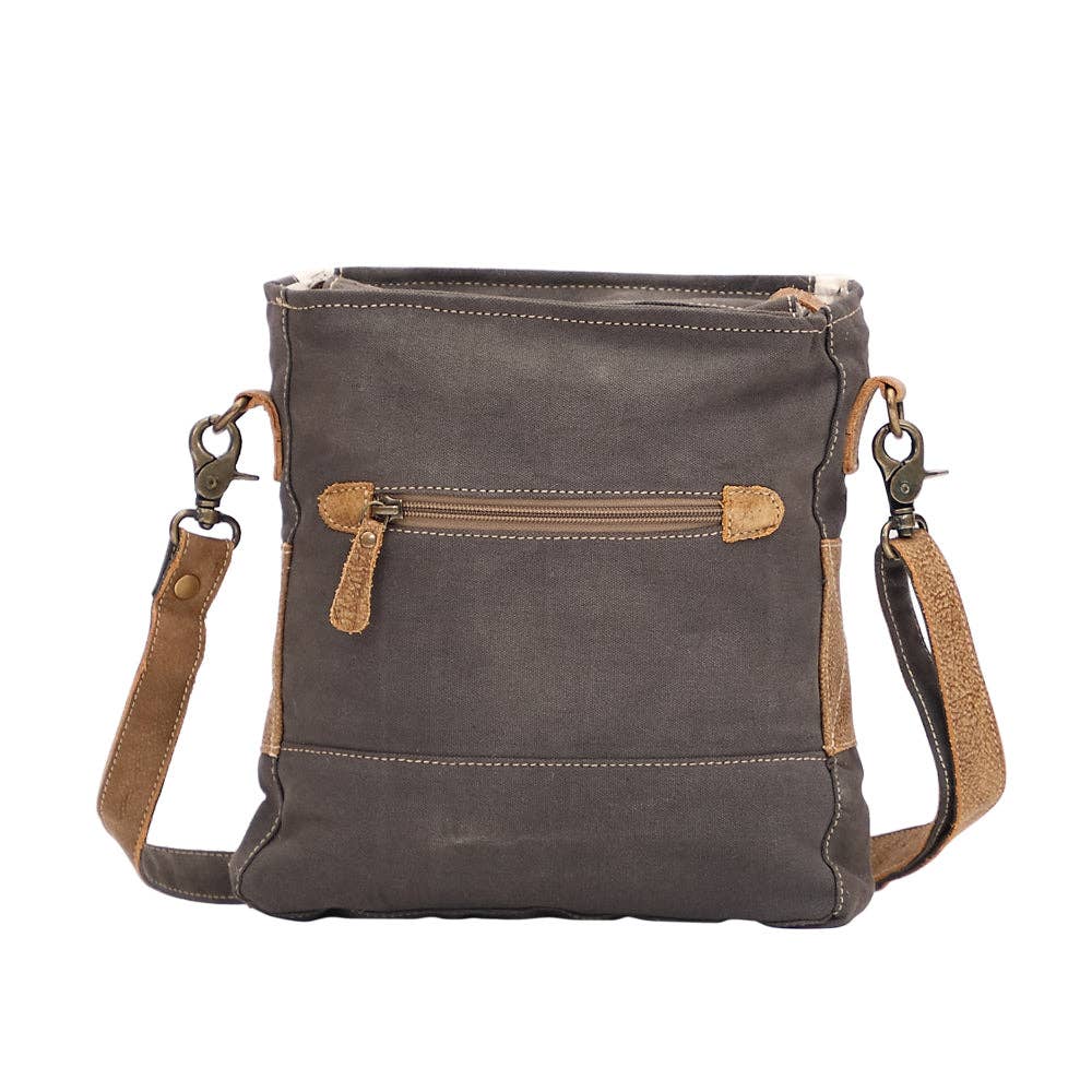 Gray leather crossbody bag with brown accents on a white background