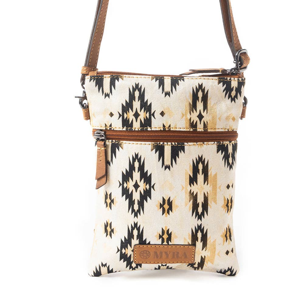 Crossbody bag with tribal pattern and brown accents on a white background