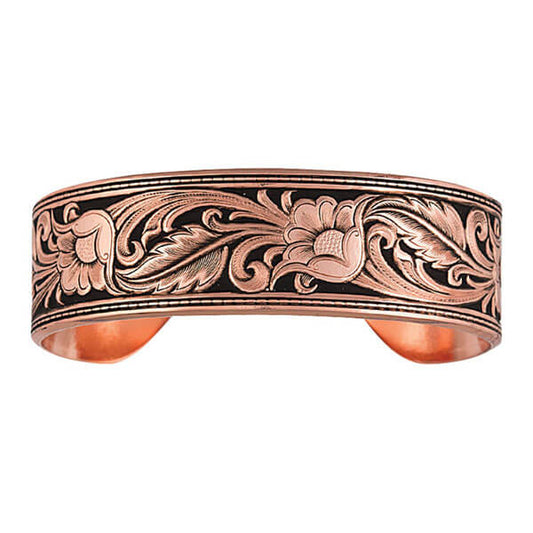 A precisely hand painted backdrop creates a leather-like piece for this western style cuff bracelet. Created with idea of transforming leather into metal this bracelet focuses on the distinctive Sheridan style. Available in Copper or Silver finishing highlights the edges of buck stitching framing the edges of the bracelet. The hand painted black contrasts and highlights the floral and leaf Sheridan leather carving pattern. Approximately 3/4" wide.