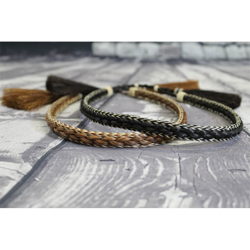 Change up the look of your hat or make a new hat feel unique like you with these braided horsehair hatbands. Thick braided center with contrast edging and two horsehiar tassels. Slide adjusts to fit any cowboy hat size.