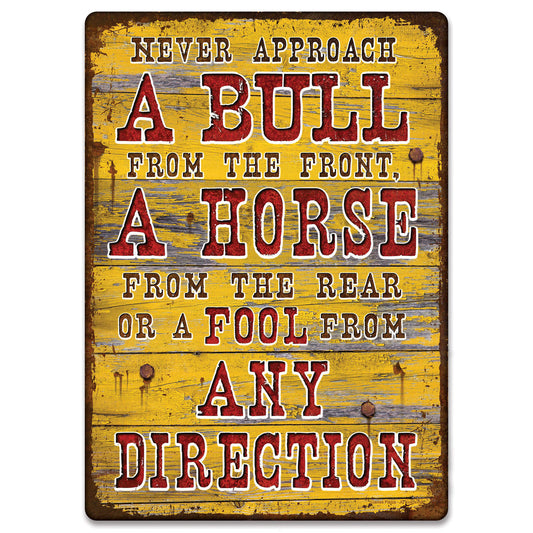 'Never approach a bull from the front, a horse from the rear or a fool from any direction.' The artwork features the message over an old barn wood back drop. Its overall dimension measures 17 inches by 12 inches wide, has rolled edges and pre-punched corner holes for easy wall mounting. A durable weatherproof finish ensures that your sign will be protected from the elements. Customize your garage, home bar, or living space with this expressive tin sign. Imported