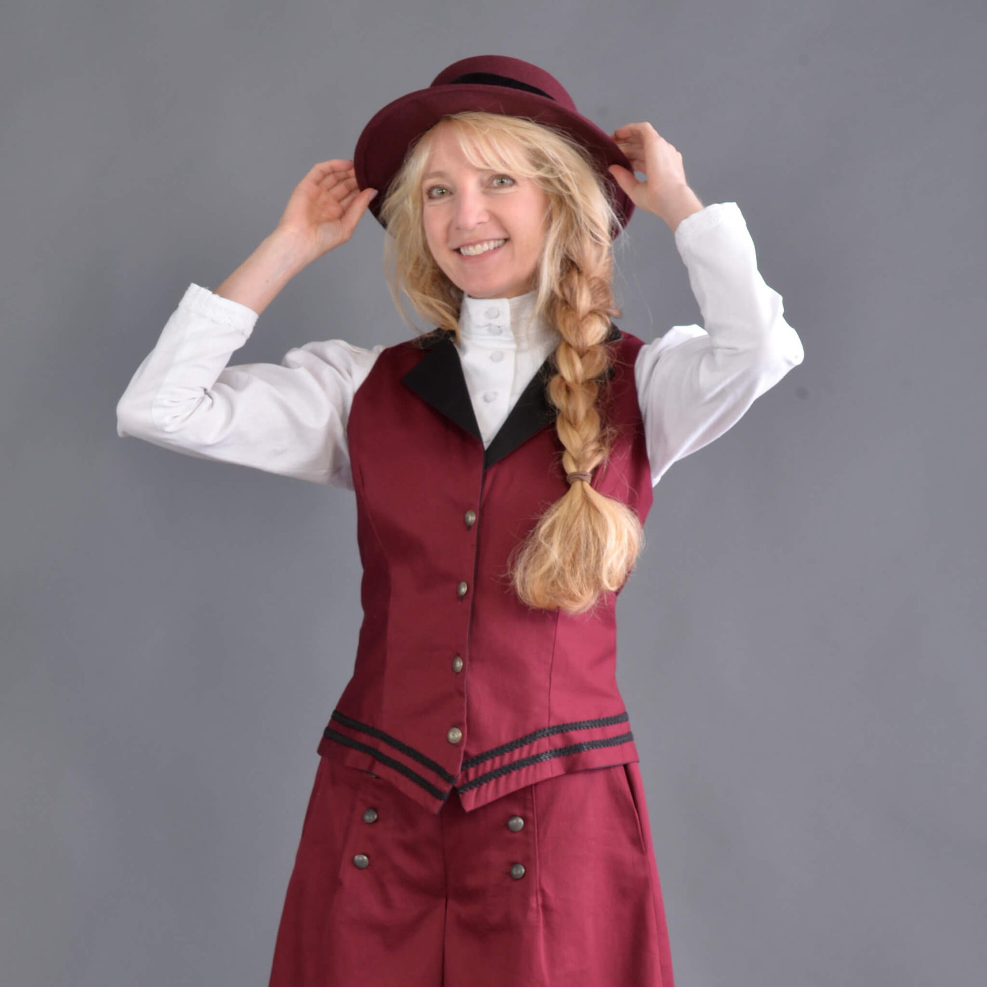 Our summer version to our riding jacket is this new Riding Vest. Stay cool in the summer heat or wear it with a blouse to stay warm and look great either way! Available in six great colors with black contrasting lapels and two rows of rayon black braid along the bottom. Silver engraved Victorian style buttons accent this vest and match our 1800’s riding skirt. Wear it with our matching riding skirts or with your favorite pair of jeans. Made of 100% cotton twill and lined in polyester.