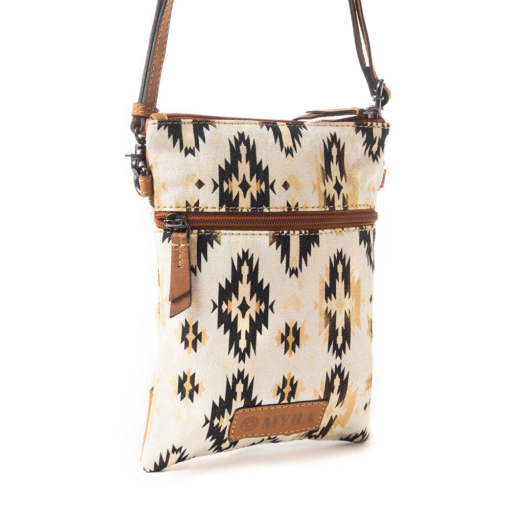 Crossbody bag with tribal pattern and brown accents on a white background