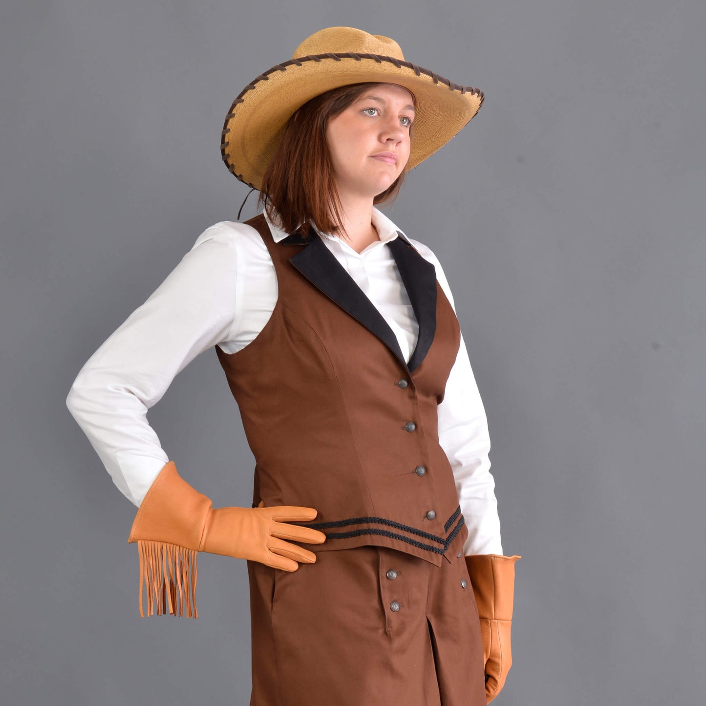 Our summer version to our riding jacket is this new Riding Vest. Stay cool in the summer heat or wear it with a blouse to stay warm and look great either way! Available in six great colors with black contrasting lapels and two rows of rayon black braid along the bottom. Silver engraved Victorian style buttons accent this vest and match our 1800’s riding skirt. Wear it with our matching riding skirts or with your favorite pair of jeans. Made of 100% cotton twill and lined in polyester.