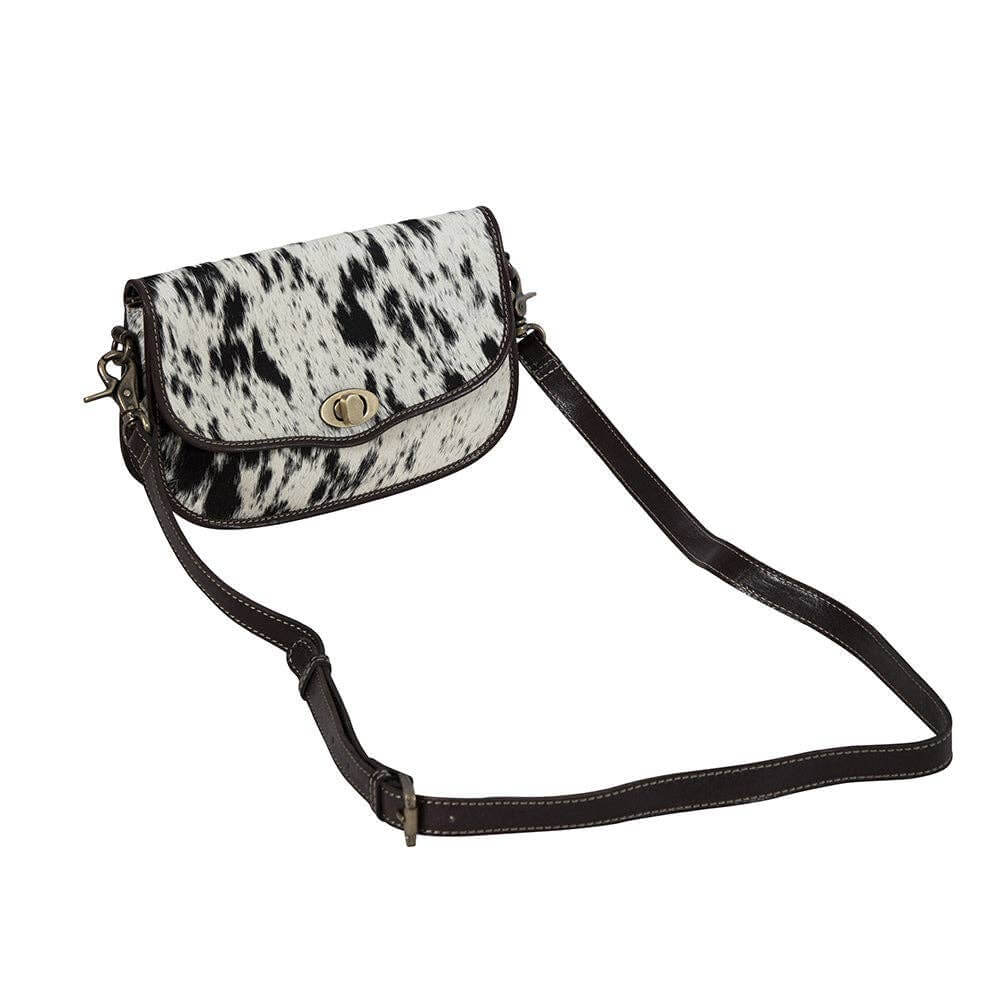 Small bag with cowhide pattern on a plain background