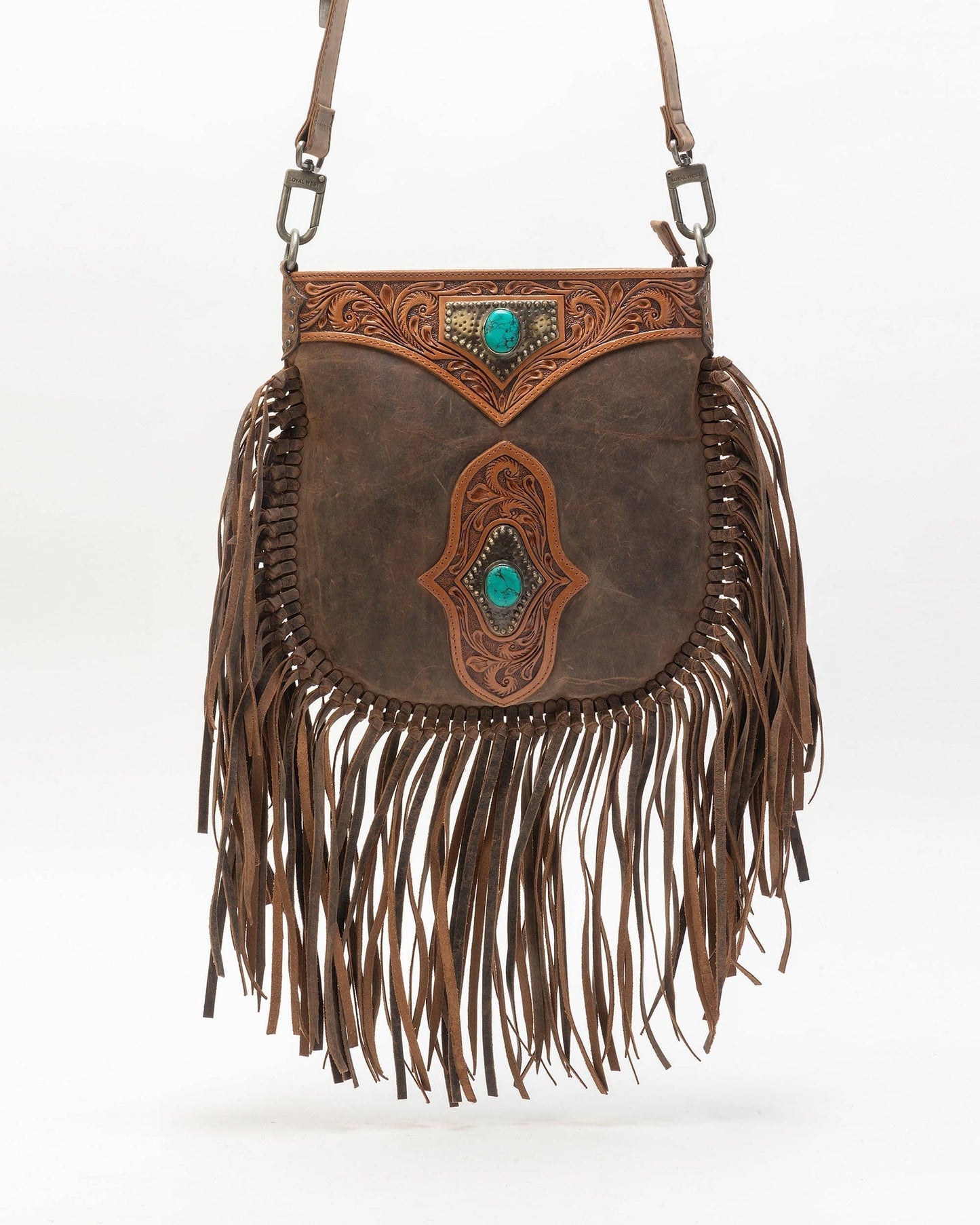 Brown leather handbag with fringe and intricate designs on a white background