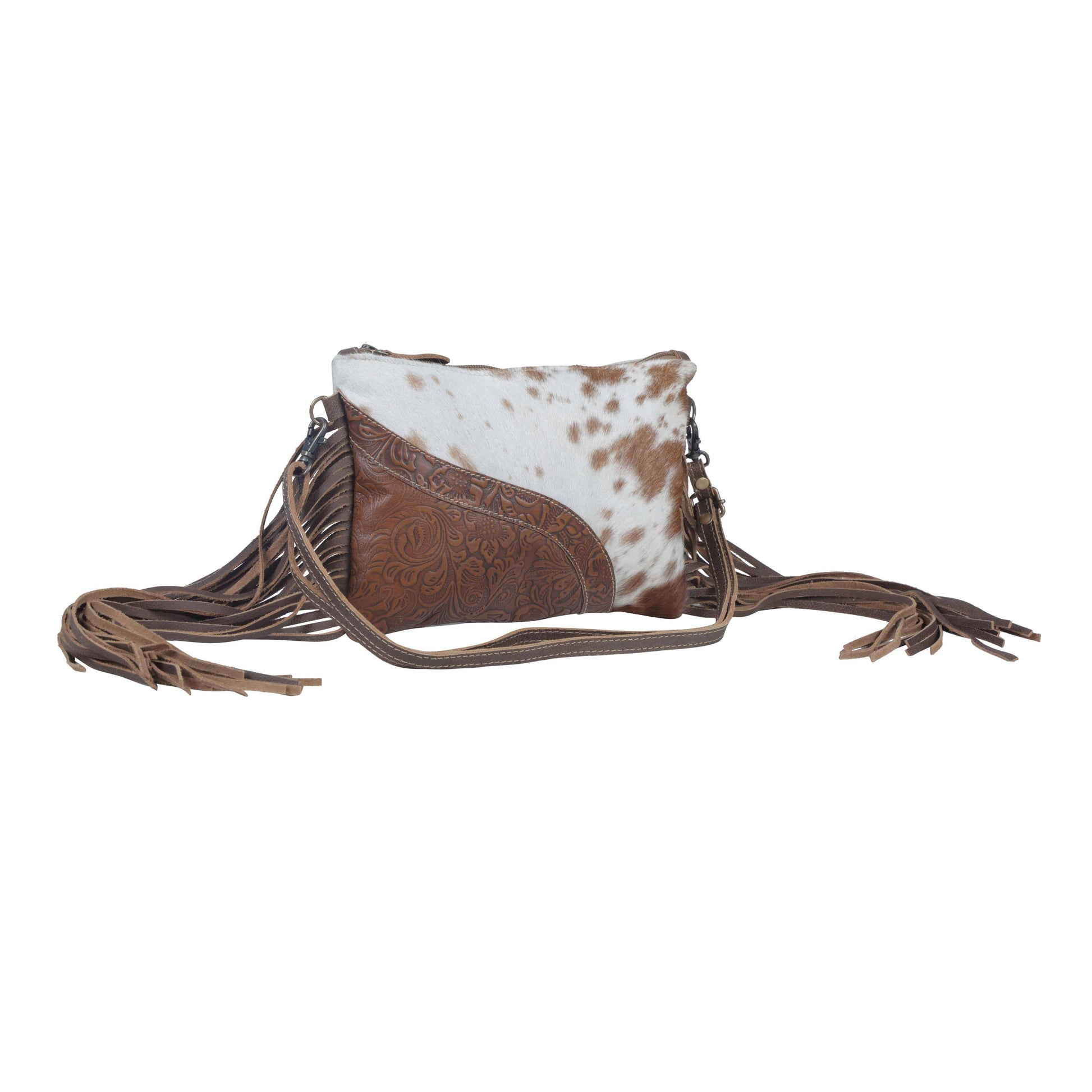 Brown and white cowhide leather crossbody bag with fringes on a white background