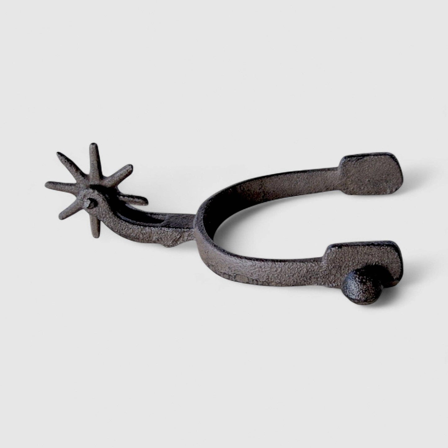 Old West Cast Iron Spur - Frontier Decor Accent showcasing detailed rowel and sturdy design.