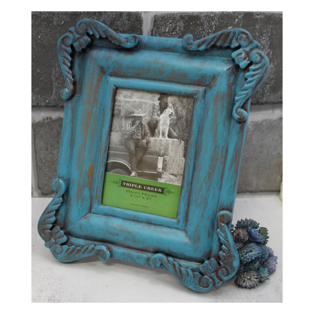 Rustic design picture frame in a modern turquoise color. Four corners of scrollwork give this frame an intricate design. Make of wood and holds a 4x6 picture. Outside frame measures and can stand vertical or horizontal.