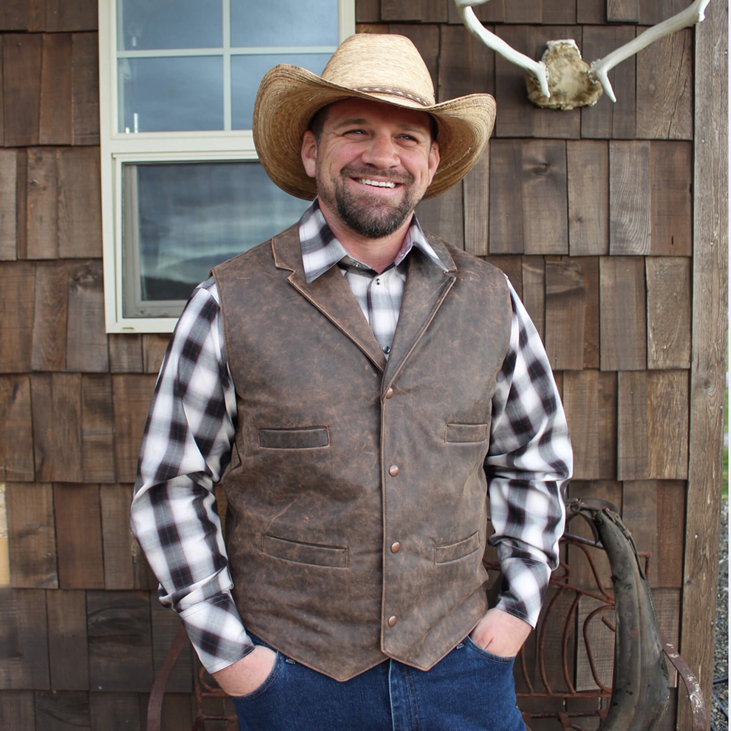 This authentic western style vest is perfect for everyday wear or Old West Re-enacting.  Our Leather Frontier vest is crafted front and back from rugged genuine leather with a rich distressed finish. A classic cut with back yoke and four handy welt pockets. Vest is lined in cotton twill and has a copper snap closure. Made in USA. Dry Clean