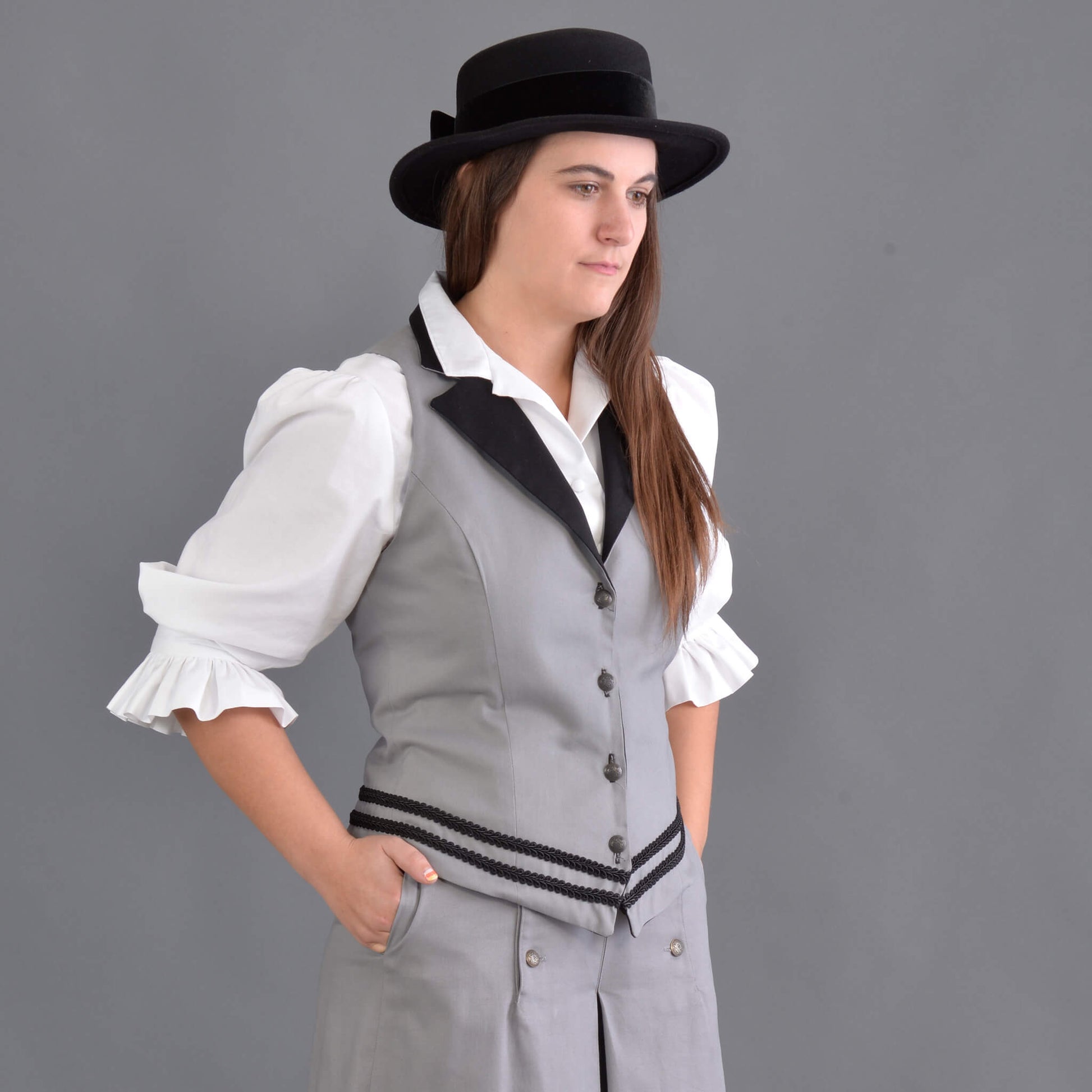 Our summer version to our riding jacket is this new Riding Vest. Stay cool in the summer heat or wear it with a blouse to stay warm and look great either way! Available in six great colors with black contrasting lapels and two rows of rayon black braid along the bottom. Silver engraved Victorian style buttons accent this vest and match our 1800’s riding skirt. Wear it with our matching riding skirts or with your favorite pair of jeans. Made of 100% cotton twill and lined in polyester.