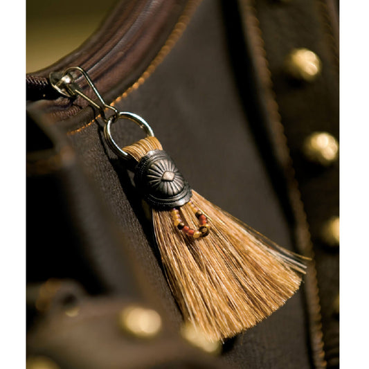 It’s all zipped up with the swish of a tail. This simple fan of authentic horse hair is a great addition to all zippers. They clip on easily to jackets, handbags, back-packs or luggage. Each tassel is adorned with a loop of tiny beads hanging from a sunburst metal Concho and hook. Order brown, black or cream horse