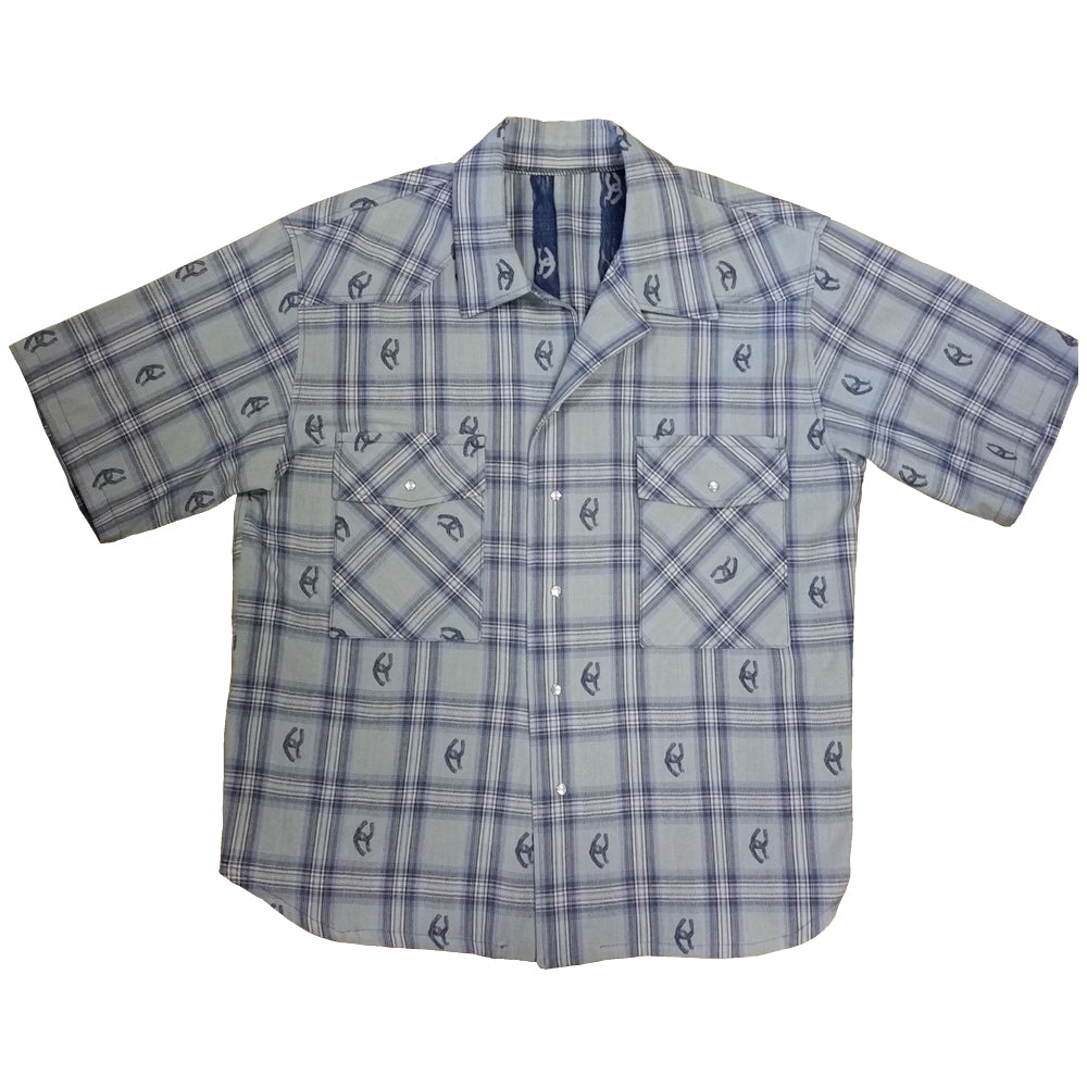 Stay stylish and cool in this short sleeve cotton shirt. Woven designs of horseshoes scatter the plaid pattern adding western flair. Two front pockets and pearl snap closures. Great for parties or concerts or any summer event that you need to look your best. Made in USA 