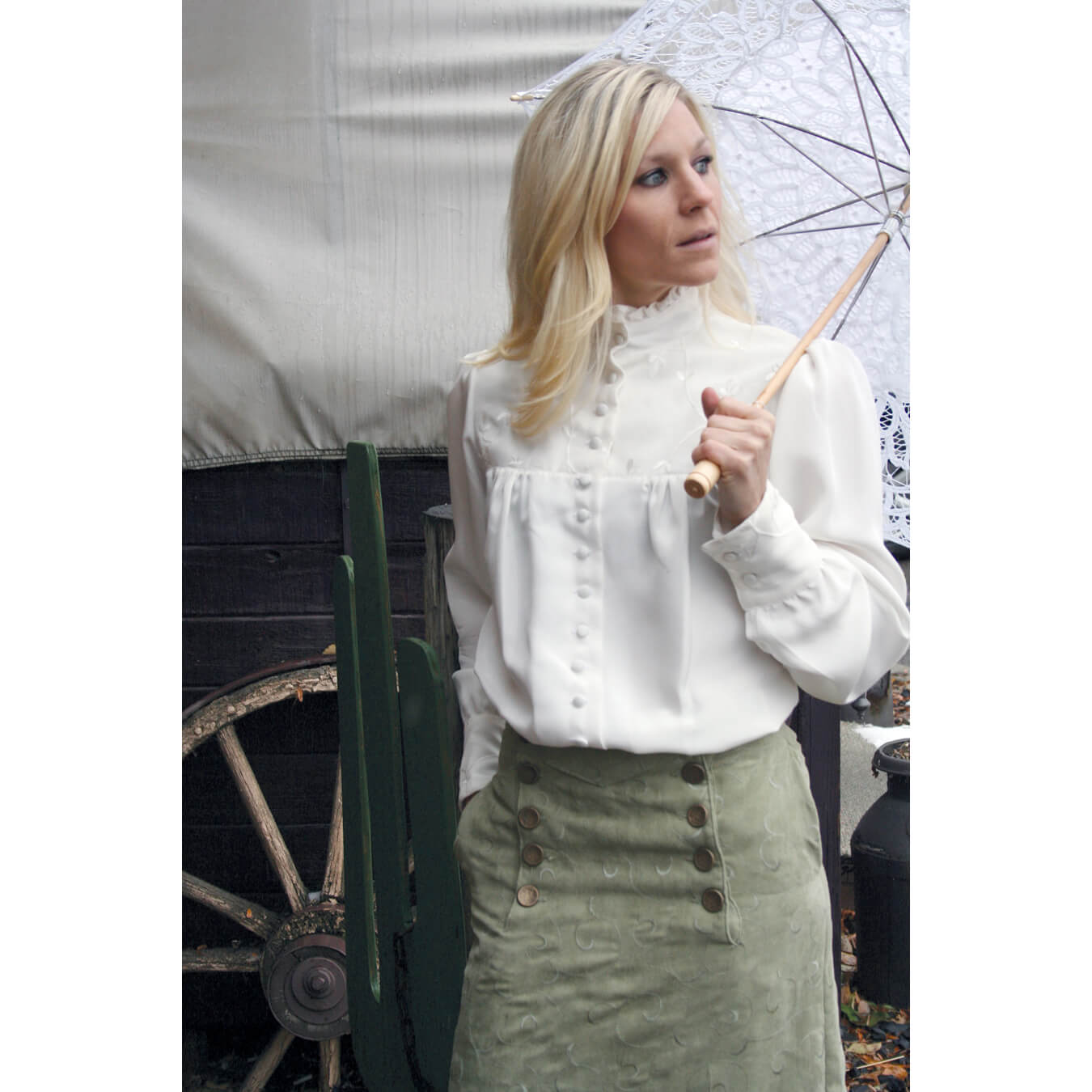 This silk blouse exudes Victorian elegance with its design that features a high neck silhouette with ½" ruffle around the neckline. It also features silk embroidered chiffon layered over the top yoke and cuffs. Bottom half of blouse is slightly gathered in the front and back with a little extra added to the length for that tucked in look. Made in 100% natural white silk in sizes XS-XXL. Made in America.