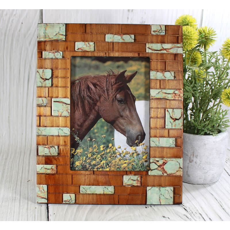 Rustic meets modern with this Turquoise Inlay Frame. The faux turquoise veneer really pops against the natural wood tone. Made from wood. Made for photographs measuring 5" x 7". Back has swing tabs for easy installation, and a thick layer of glass protects your image. Wipe clean. Imported.