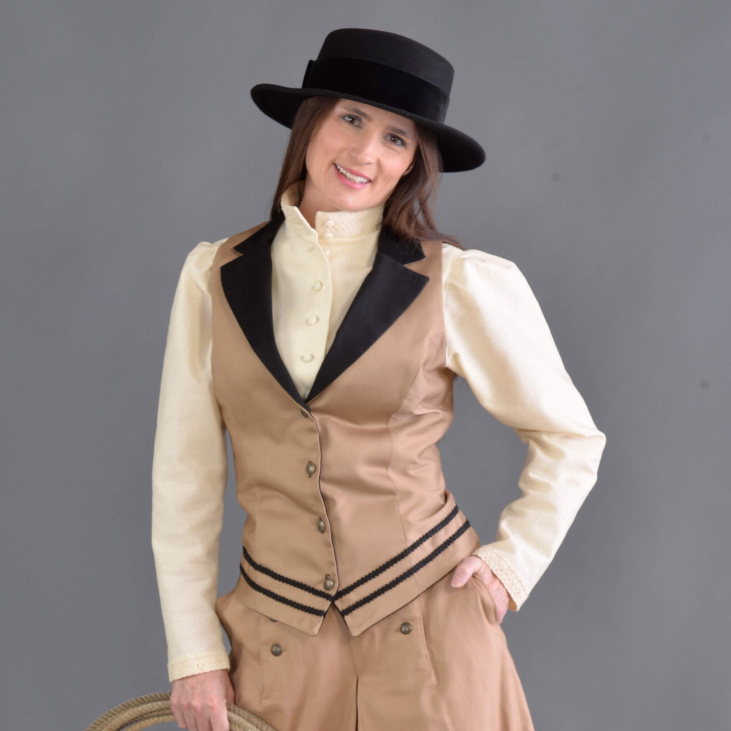 Our summer version to our riding jacket is this new Riding Vest. Stay cool in the summer heat or wear it with a blouse to stay warm and look great either way! Available in six great colors with black contrasting lapels and two rows of rayon black braid along the bottom. Silver engraved Victorian style buttons accent this vest and match our 1800’s riding skirt. Wear it with our matching riding skirts or with your favorite pair of jeans. Made of 100% cotton twill and lined in polyester.