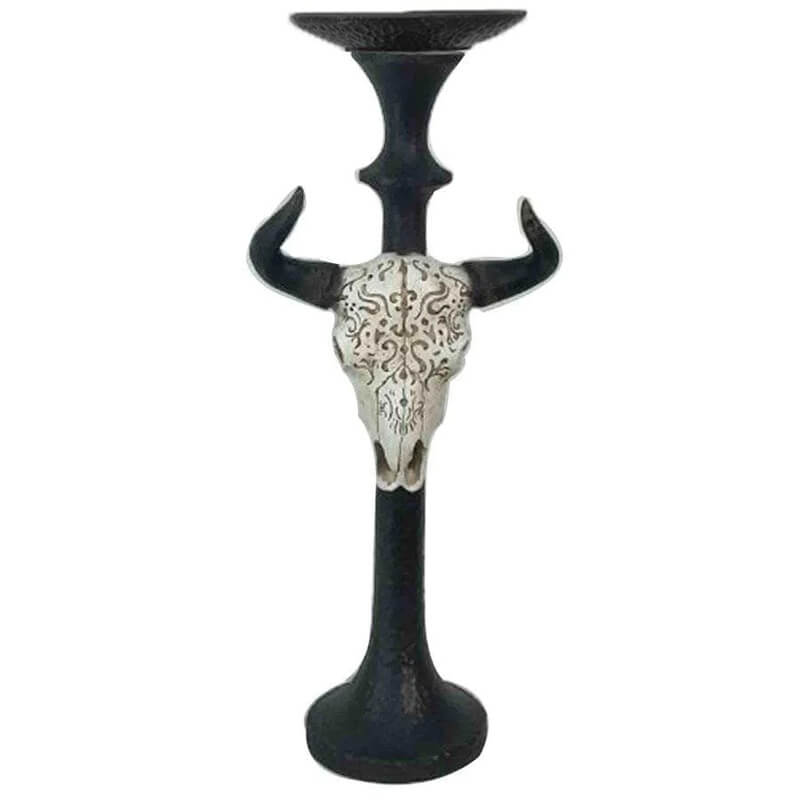 This Skull Taper Candle Holder will add a statement in any room. The skull features carved designs for added interest. Sold individually. Designed to hold up to a 3" pillar candle (candle not included). 