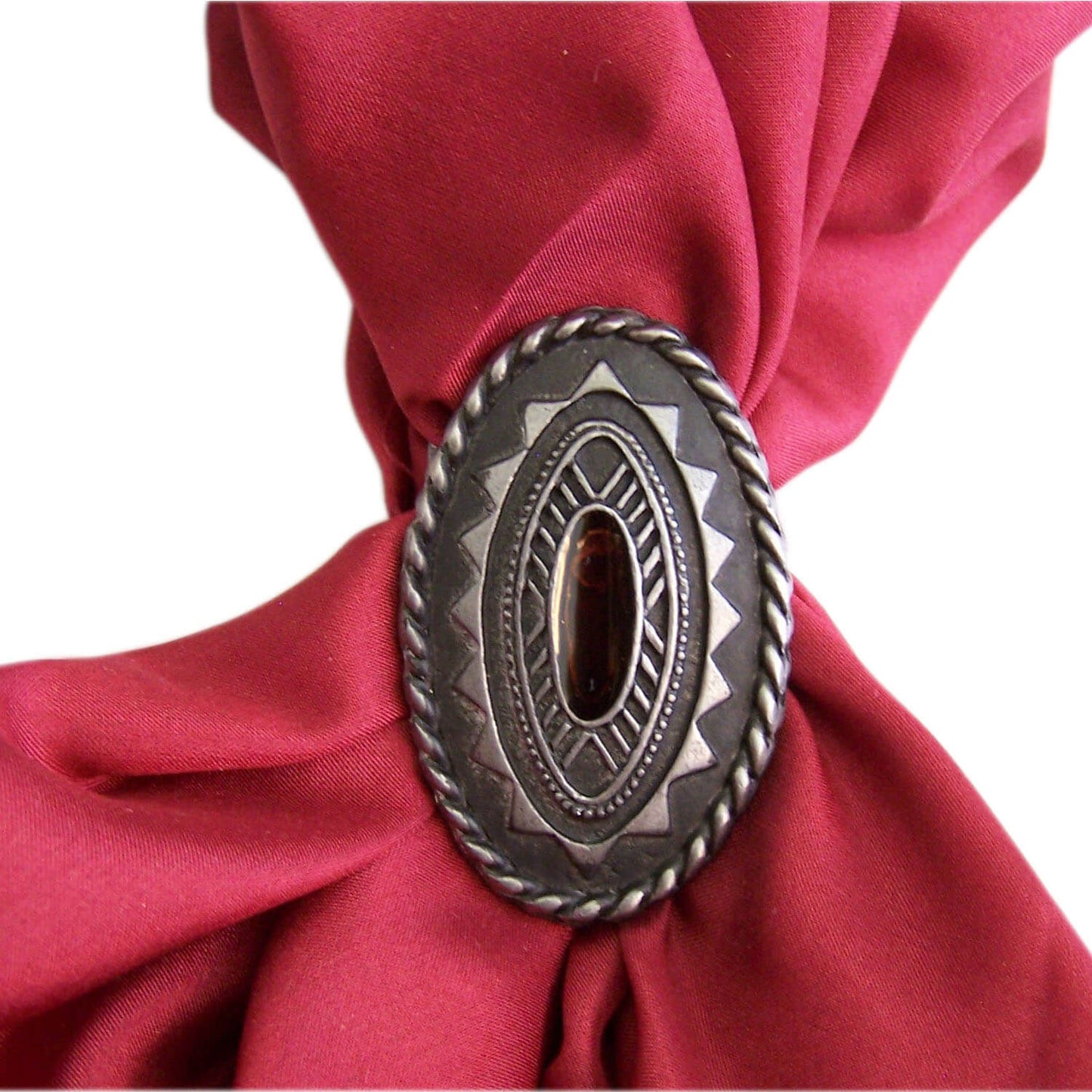 When you need a western style scarf slide our southwestern one will enhance your western attire. A great oval shape with Aztec geometric design. Made out of a silver aged looking metal, a very sturdy back made in the USA