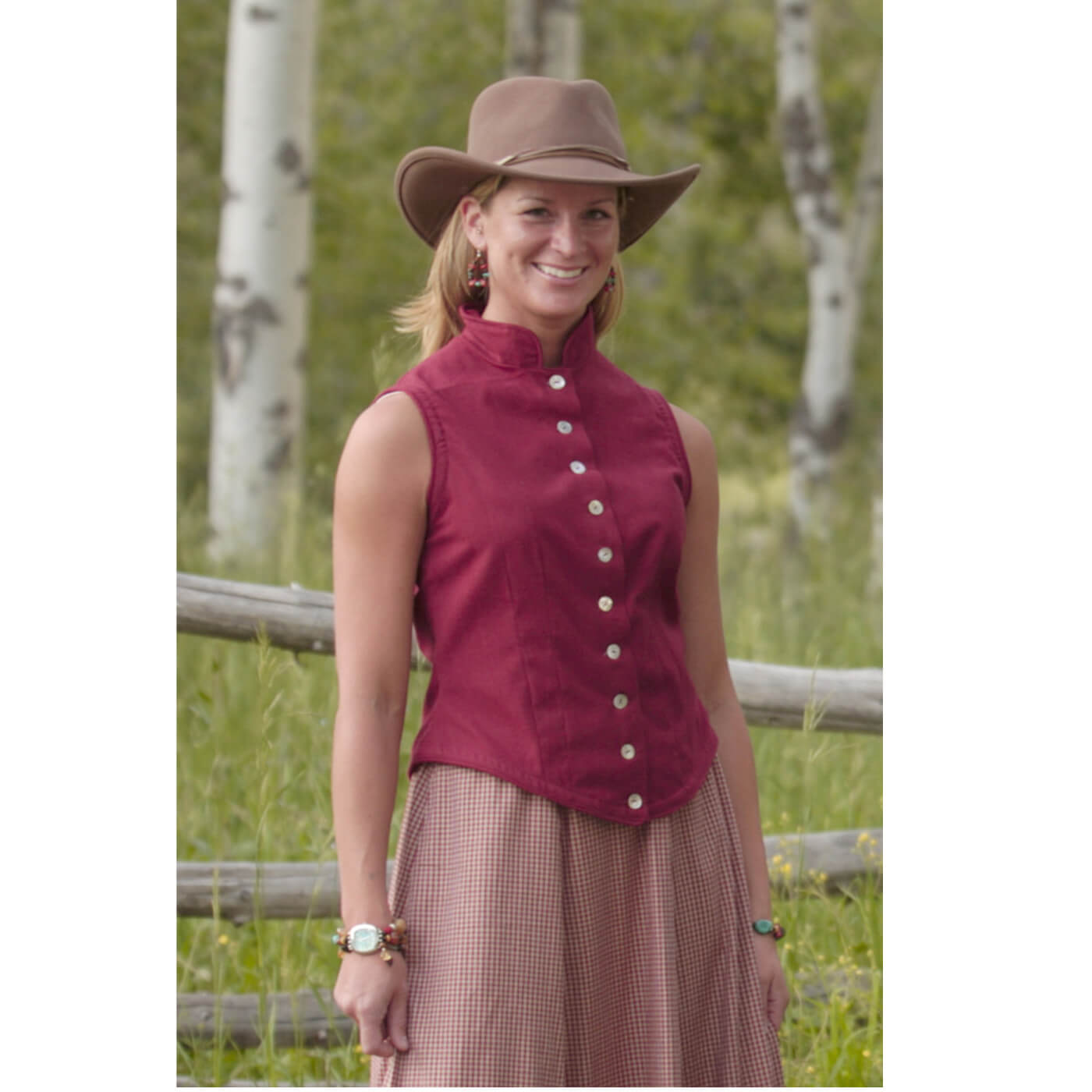 This fun fitted vest can flatter any figure. Constructed of lightweight homespun flannel in a stunning shade of wine. This vest features ten iridescent natural shell buttons and trimmed in self-piping. Made of 100% Cotton. Made in USA